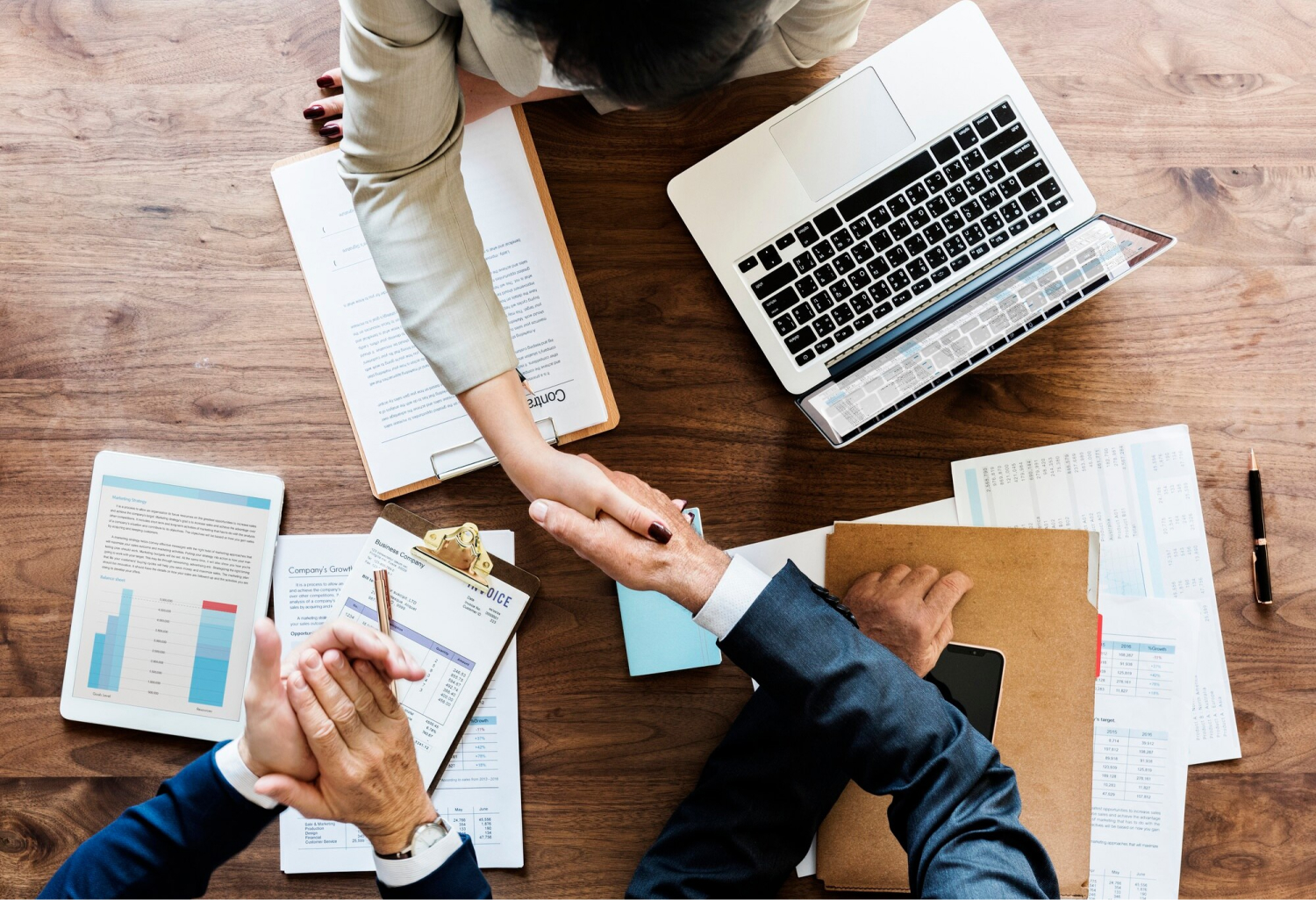 Business people shaking hands together