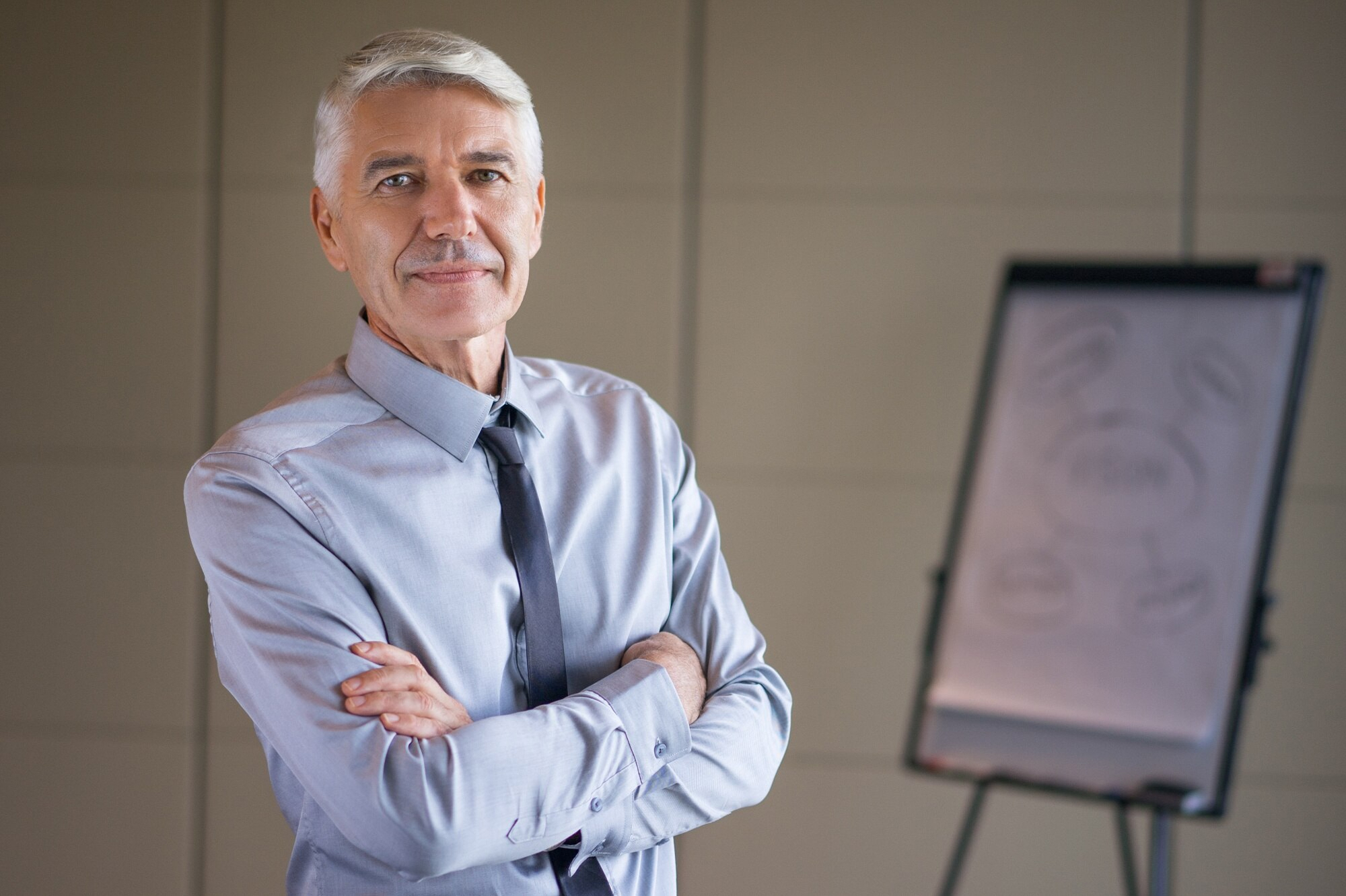 Closeup of senior lecturer with arms crossed